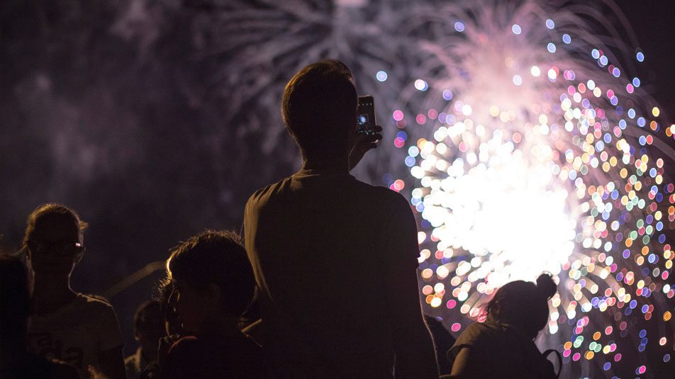 a family enjoying evening fireworks